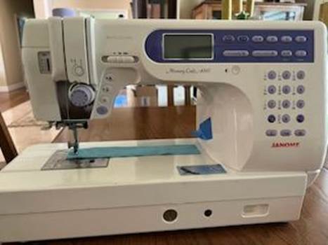 A sewing machine on a table

Description automatically generated