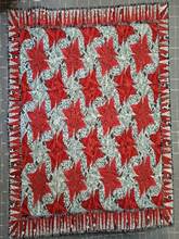 A red and white quilt with black and white patterns

Description automatically generated