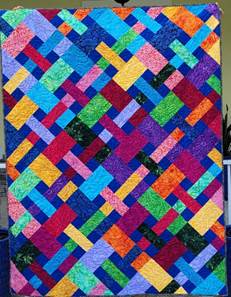 A colorful quilt with rectangles

Description automatically generated