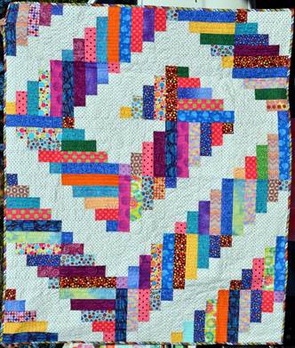 A colorful quilt with white and pink squares

Description automatically generated