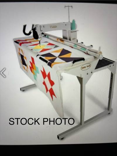 A machine with a quilt on it

Description automatically generated