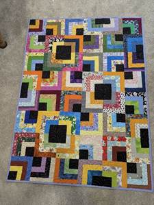 A colorful quilt on the floor

AI-generated content may be incorrect.